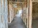Interior view of framed home under construction, showcasing the layout and stud walls, wires and insulation at 46905 W Old Timer Rd, Maricopa, AZ 85139