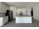 Bright kitchen features stainless steel appliances, white cabinets, an island and tile backsplash at 46905 W Old Timer Rd, Maricopa, AZ 85139