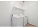 Well-lit laundry room with a washer and dryer, plus convenient shelving at 46905 W Old Timer Rd, Maricopa, AZ 85139