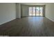 Spacious living room featuring hard flooring and sliding glass doors to the backyard at 46905 W Old Timer Rd, Maricopa, AZ 85139