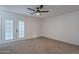 Bright bedroom with double doors and ceiling fan at 4914 E Lake Point Cir, Phoenix, AZ 85044