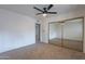 Bedroom with mirrored closet and ceiling fan at 4914 E Lake Point Cir, Phoenix, AZ 85044