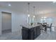Spacious kitchen with granite island, pendant lighting, and white cabinetry at 4914 E Lake Point Cir, Phoenix, AZ 85044