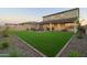 Artificial turf and a covered patio with seating area at 4928 W Capistrano Ave, Laveen, AZ 85339