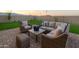Artificial turf backyard with wicker patio furniture at 4928 W Capistrano Ave, Laveen, AZ 85339