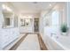 Elegant bathroom with double sinks, soaking tub, and separate shower at 4928 W Capistrano Ave, Laveen, AZ 85339