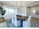 Spacious dining area with chandelier, large windows, and decorative wall at 4928 W Capistrano Ave, Laveen, AZ 85339