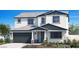 Two-story home with gray and white exterior, and a two-car garage at 4928 W Capistrano Ave, Laveen, AZ 85339
