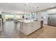 Open kitchen with white cabinetry, large island, and views into the living room at 4928 W Capistrano Ave, Laveen, AZ 85339