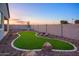 Artificial turf and stone create a low-maintenance backyard at 4934 W Weeping Willow Way, Laveen, AZ 85339