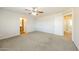 Spacious bedroom with carpeting, ceiling fan and en-suite bathroom at 5866 S 237Th Ln, Buckeye, AZ 85326