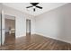 Bedroom with wood floors, access to hall and another room at 6023 W Kimberly Way, Glendale, AZ 85308