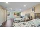 Spacious bedroom with two beds, wood laminate flooring, and abundant natural light at 6720 E Phelps Rd, Scottsdale, AZ 85254