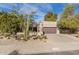 Charming single-level home with well-manicured desert landscaping and an attached garage at 6720 E Phelps Rd, Scottsdale, AZ 85254