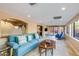 Bright living room with a light blue sofa and a window into the verdant backyard at 6720 E Phelps Rd, Scottsdale, AZ 85254