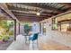 Cozy covered patio with tile flooring, ceiling fan, and comfortable seating area at 6720 E Phelps Rd, Scottsdale, AZ 85254