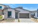Stunning modern home with neutral stucco, stone accents, stylish garage door and desert landscaping at 6727 N 9Th Dr, Phoenix, AZ 85013
