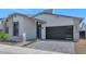 Beautiful modern home with neutral stucco, stone accents, stylish garage door and desert landscaping at 6727 N 9Th Dr, Phoenix, AZ 85013