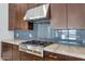 Gourmet kitchen featuring stainless steel gas range, subway tile backsplash, and marble countertops at 6727 N 9Th Dr, Phoenix, AZ 85013