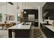 Modern kitchen with dark cabinetry, quartz countertops, and stainless steel appliances at 6727 N 9Th Dr, Phoenix, AZ 85013