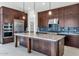 Gourmet kitchen with custom cabinets, large island, stainless steel appliances, and pendant lighting at 6727 N 9Th Dr, Phoenix, AZ 85013