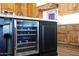 Modern kitchen island with wine cooler and granite countertop at 6860 E Gray Fox Ct, Gold Canyon, AZ 85118