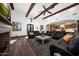 Relaxing living room with fireplace, wood beams, and comfortable seating at 6860 E Gray Fox Ct, Gold Canyon, AZ 85118