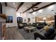 Living room with exposed beams, fireplace, and kitchen view at 6860 E Gray Fox Ct, Gold Canyon, AZ 85118