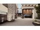 Modern entryway with stone and wood accents leading to a glass-walled staircase at 7256 N 40Th St # 6, Paradise Valley, AZ 85253