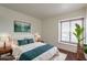 Bright bedroom with a plush bed, natural light from the window, and sleek wooden nightstands at 8446 N 34Th Dr, Phoenix, AZ 85051