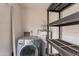 Laundry area with washer, dryer and storage shelving at 8446 N 34Th Dr, Phoenix, AZ 85051