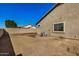 Backyard with a view of house exterior and AC unit at 10036 W Parkway Rd, Tolleson, AZ 85353