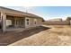 View of backyard with covered patio and unlandscaped area at 10036 W Parkway Rd, Tolleson, AZ 85353