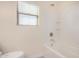 Bathroom with a bathtub, window, and tiled shower surround at 10036 W Parkway Rd, Tolleson, AZ 85353