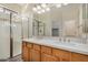 Modern bathroom boasts double sinks, quartz countertops, and a glass shower at 10036 W Parkway Rd, Tolleson, AZ 85353