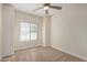 Well-lit bedroom featuring carpeted floors and a ceiling fan at 10036 W Parkway Rd, Tolleson, AZ 85353