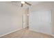 Spacious bedroom with carpet, double door closet, and adjacent door at 10036 W Parkway Rd, Tolleson, AZ 85353