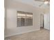 Well-lit bedroom featuring tile floors and a ceiling fan at 10036 W Parkway Rd, Tolleson, AZ 85353