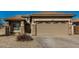 Single-story home with a two-car garage and neutral color palette at 10036 W Parkway Rd, Tolleson, AZ 85353