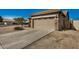 View of the home's exterior, highlighting the garage and landscaping at 10036 W Parkway Rd, Tolleson, AZ 85353