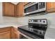 Stainless steel range and microwave in a light wood kitchen at 10036 W Parkway Rd, Tolleson, AZ 85353