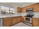 Modern kitchen with stainless steel appliances and wood cabinets at 10036 W Parkway Rd, Tolleson, AZ 85353