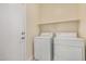 Laundry room with washer, dryer, and overhead shelving at 10036 W Parkway Rd, Tolleson, AZ 85353