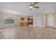 Open floor plan living room with kitchen and tile floors at 10036 W Parkway Rd, Tolleson, AZ 85353