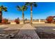 Pathway to open backyard with mature palm trees at 10436 W Devonshire Ave, Phoenix, AZ 85037