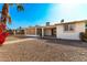 Backyard view of home with screened patio and walkway at 10436 W Devonshire Ave, Phoenix, AZ 85037