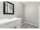 Clean bathroom with white vanity and a shower/tub combo at 10436 W Devonshire Ave, Phoenix, AZ 85037