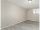 Well-lit bedroom featuring neutral walls and wood-look floors at 10436 W Devonshire Ave, Phoenix, AZ 85037