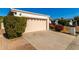 House exterior showcasing a garage and well-manicured landscaping at 10436 W Devonshire Ave, Phoenix, AZ 85037