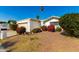 Single-story home with a carport and nicely landscaped front yard at 10436 W Devonshire Ave, Phoenix, AZ 85037